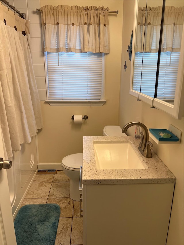 bathroom featuring tile patterned flooring, vanity, toilet, a shower with curtain, and visible vents