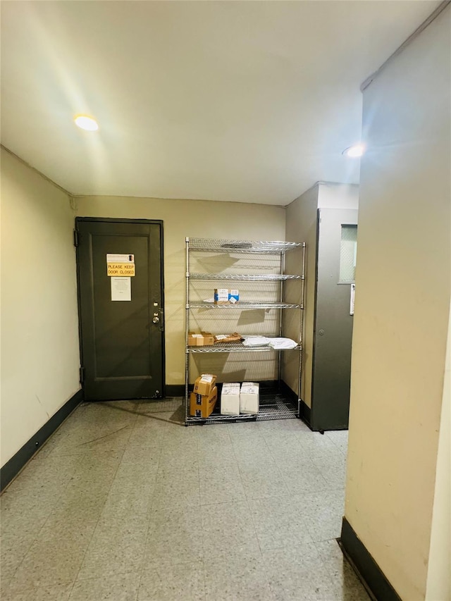 entryway with tile patterned floors, baseboards, and recessed lighting