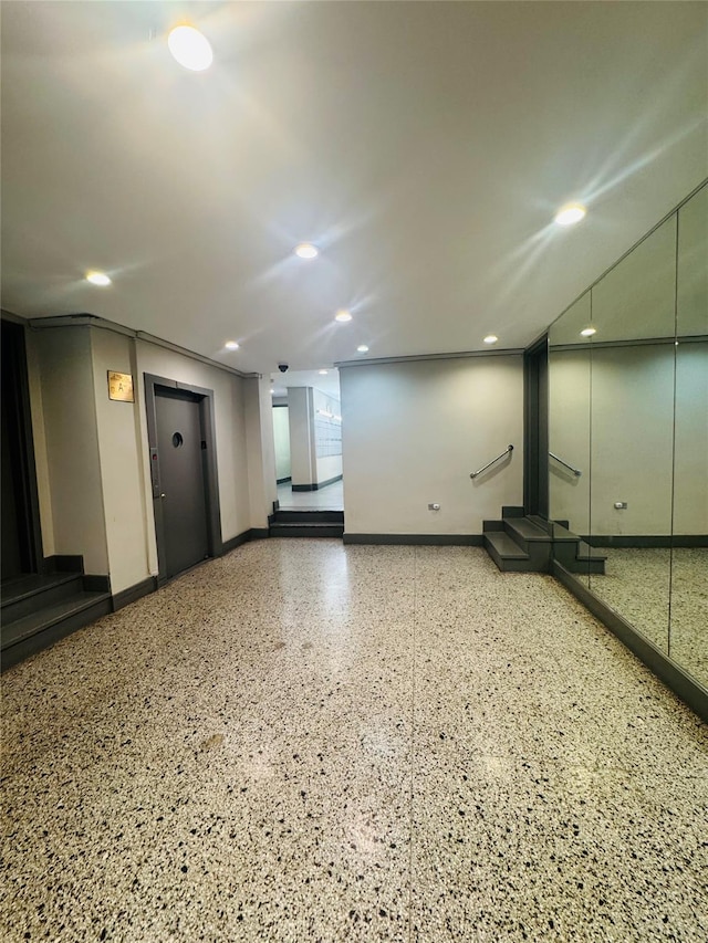 below grade area featuring baseboards and recessed lighting