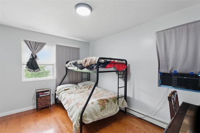 50 Darerka St, Amityville, NY 11701 - bedroom featuring a baseboard radiator, wood finished floors, and baseboards