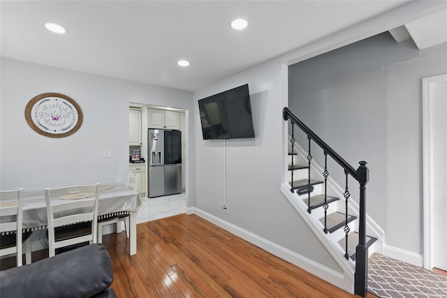 50 Darerka St, Amityville, NY 11701 - dining room with light wood-type flooring, baseboards, stairway, and recessed lighting