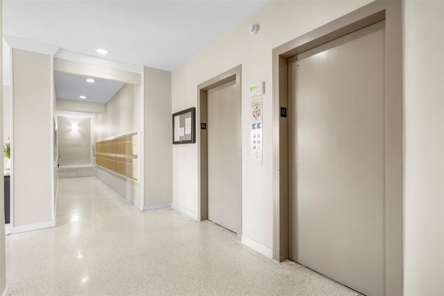 corridor with baseboards, elevator, recessed lighting, and light speckled floor