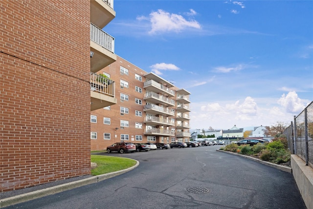 view of building exterior with uncovered parking