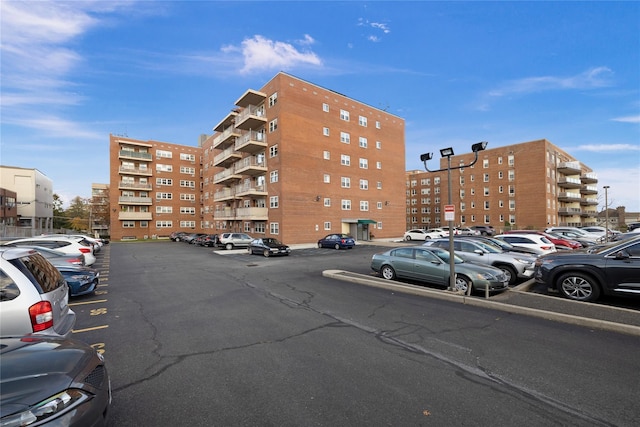 view of building exterior with uncovered parking