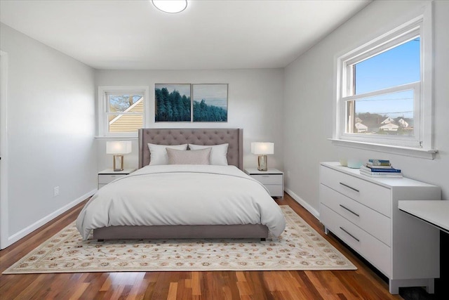 bedroom featuring wood finished floors and baseboards