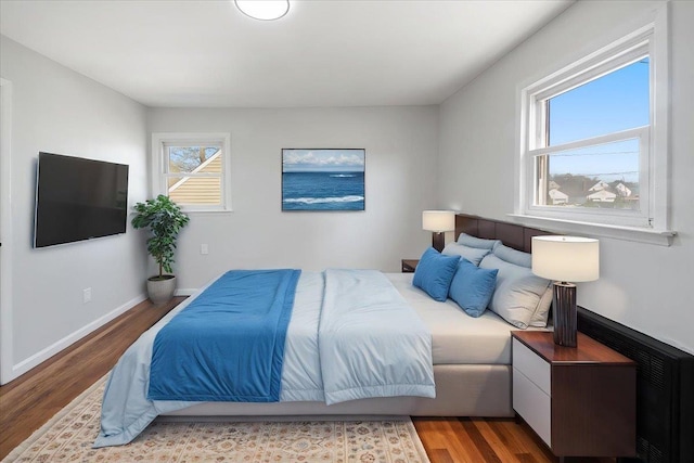 bedroom featuring baseboards and wood finished floors