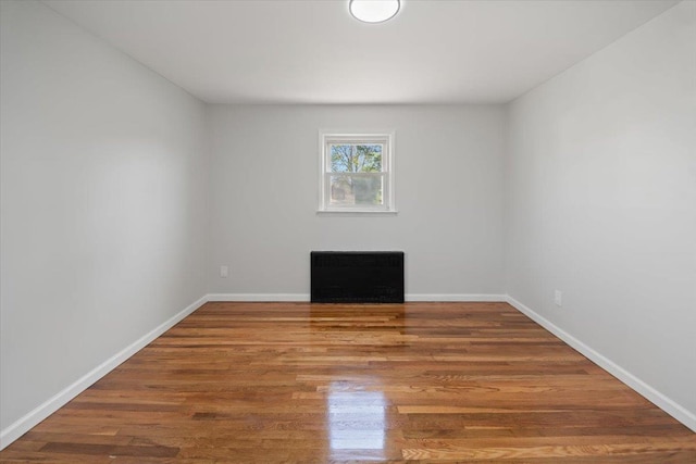 unfurnished room with wood finished floors and baseboards