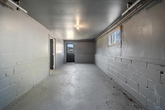 below grade area featuring concrete block wall