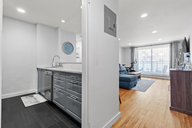 377 Westchester Ave Unit 6C, Port Chester, NY 10573 - kitchen featuring a sink, electric panel, gray cabinetry, baseboards, and recessed lighting