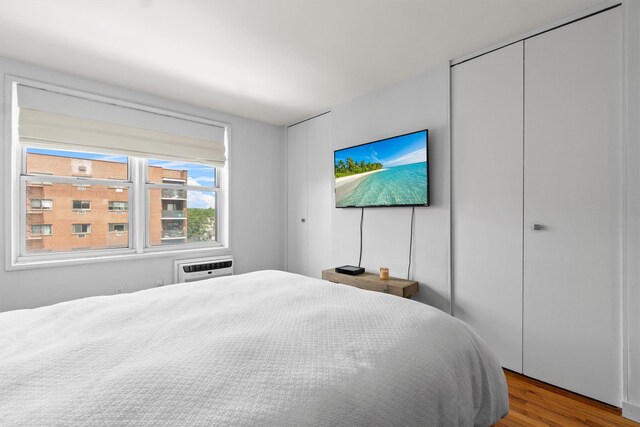 377 Westchester Ave Unit 6C, Port Chester, NY 10573 - bedroom featuring wood finished floors and a wall mounted air conditioner