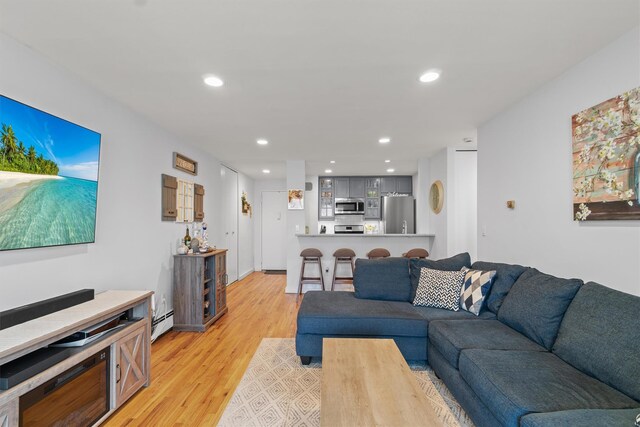 377 Westchester Ave Unit 6C, Port Chester, NY 10573 - living room featuring light wood-type flooring, a baseboard radiator, and recessed lighting