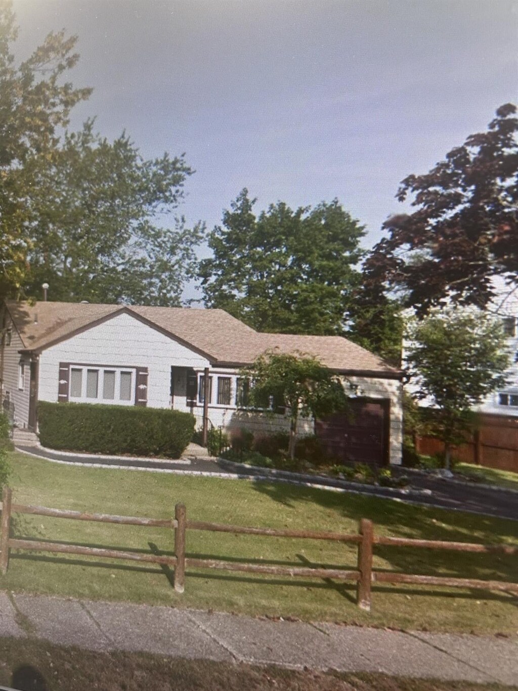 ranch-style house featuring fence private yard and a front lawn