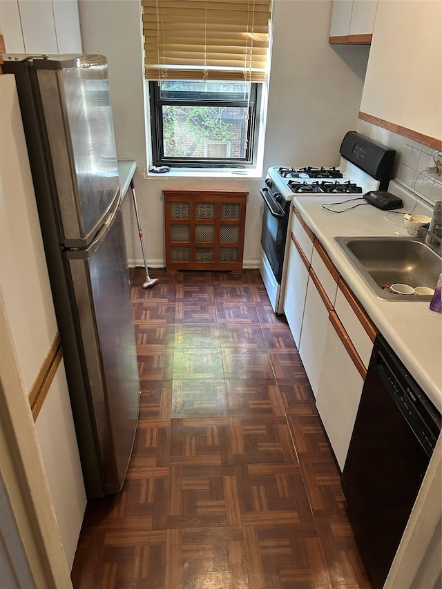 83-75 118th St Unit 4H, Kew Gardens, NY 11415 - kitchen with black dishwasher, gas range oven, a sink, freestanding refrigerator, and light countertops