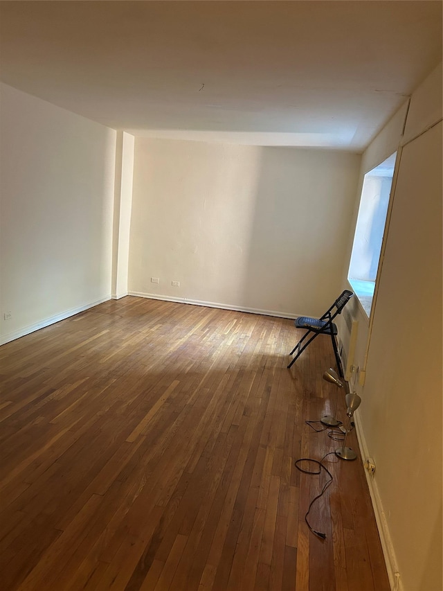 83-75 118th St Unit 4H, Kew Gardens, NY 11415 - spare room with dark wood-type flooring and baseboards