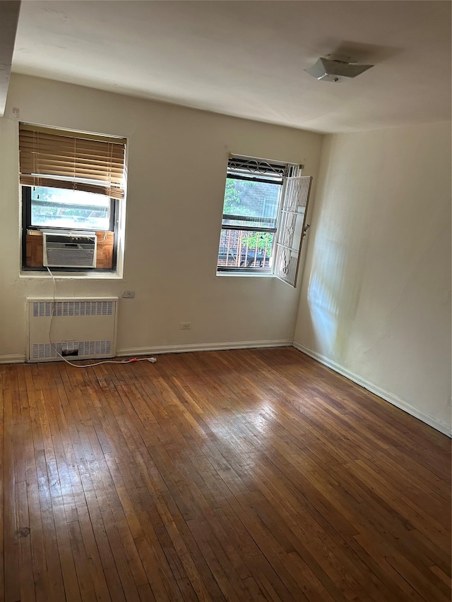83-75 118th St Unit 4H, Kew Gardens, NY 11415 - empty room with radiator, hardwood / wood-style floors, cooling unit, and baseboards