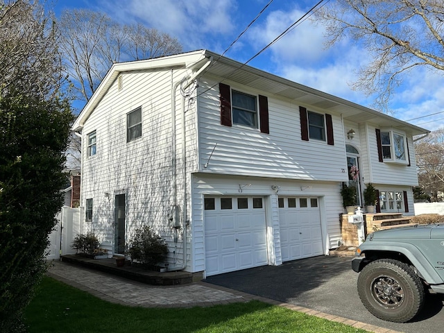 33 41st St, Islip, NY 11751 - view of front facade with aphalt driveway and a garage
