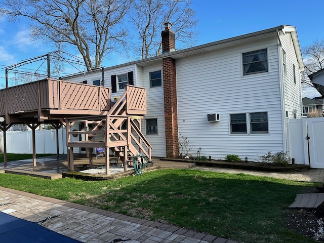 33 41st St, Islip, NY 11751 - back of property featuring a lawn, a gate, fence, and a chimney