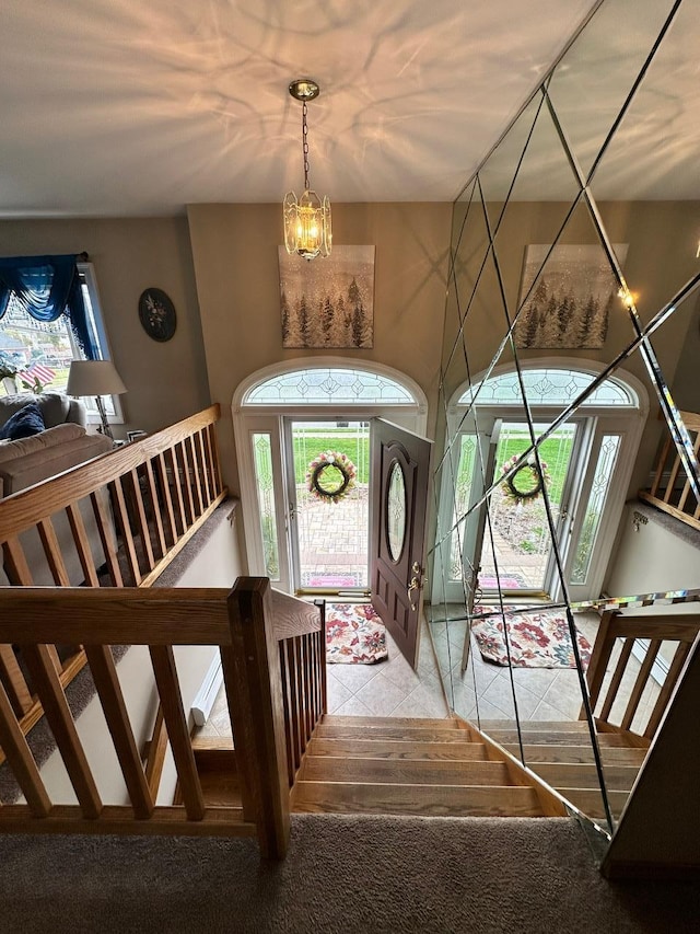 33 41st St, Islip, NY 11751 - entryway with tile patterned floors, a chandelier, and stairway