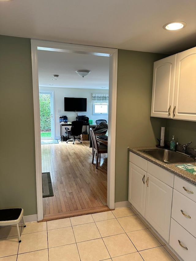 33 41st St, Islip, NY 11751 - kitchen featuring white cabinetry, dark countertops, a wealth of natural light, and a sink