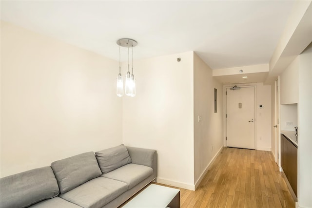 living room featuring baseboards and light wood finished floors