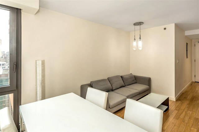 living area with baseboards and light wood-style flooring