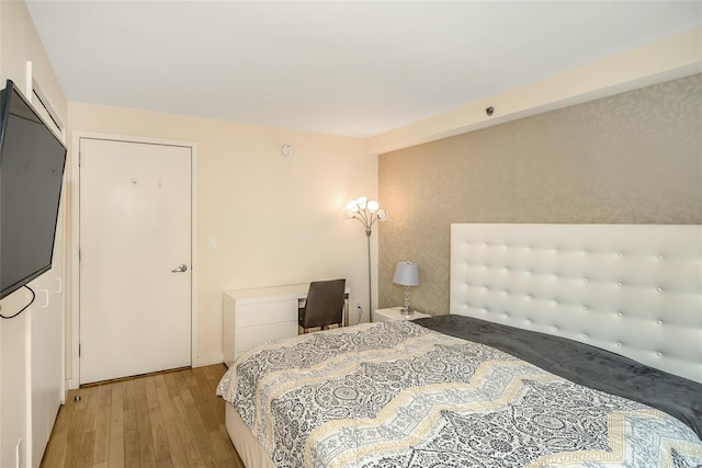 bedroom with baseboards and light wood-style flooring