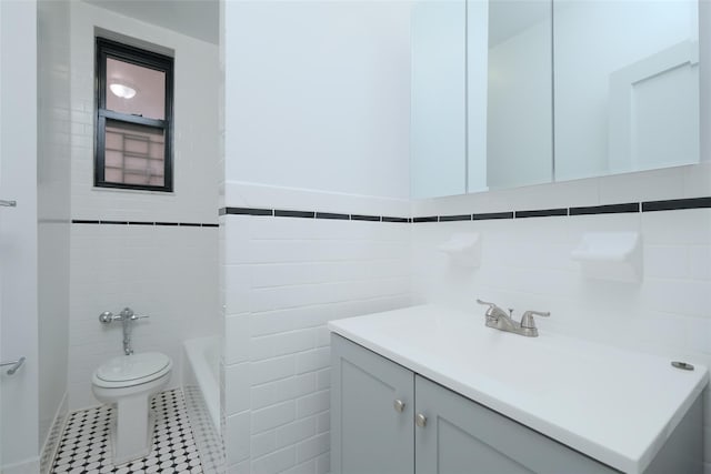 full bath featuring tile walls, toilet, a bathtub, and vanity