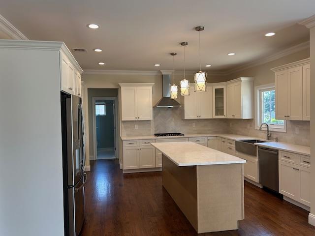 267 N Elm St, Massapequa, NY 11758 - kitchen with wall chimney range hood, appliances with stainless steel finishes, light countertops, recessed lighting, and white cabinetry
