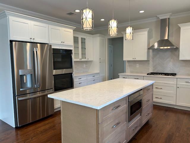 267 N Elm St, Massapequa, NY 11758 - kitchen featuring appliances with stainless steel finishes, wall chimney range hood, white cabinetry, recessed lighting, and dark wood-style floors