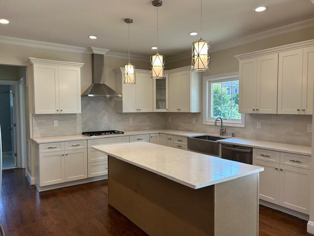 267 N Elm St, Massapequa, NY 11758 - kitchen featuring wall chimney range hood, a sink, stainless steel dishwasher, white cabinetry, and light countertops
