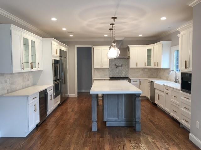 267 N Elm St, Massapequa, NY 11758 - kitchen featuring wine cooler, stainless steel appliances, a sink, glass insert cabinets, and light countertops