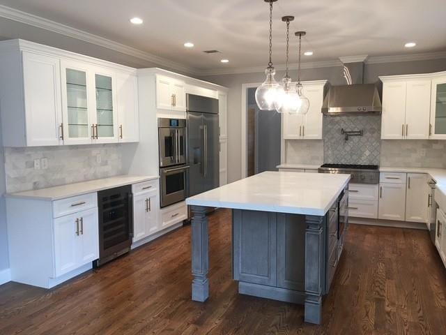 267 N Elm St, Massapequa, NY 11758 - kitchen featuring beverage cooler, light countertops, glass insert cabinets, white cabinets, and recessed lighting