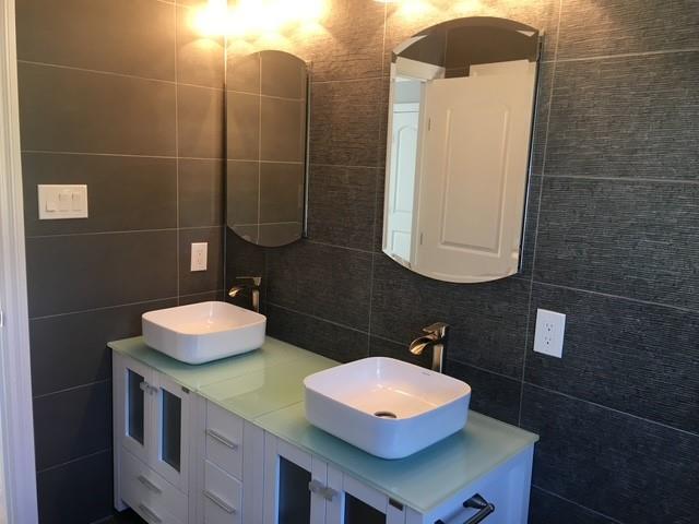 267 N Elm St, Massapequa, NY 11758 - bathroom with tile walls, decorative backsplash, and double vanity