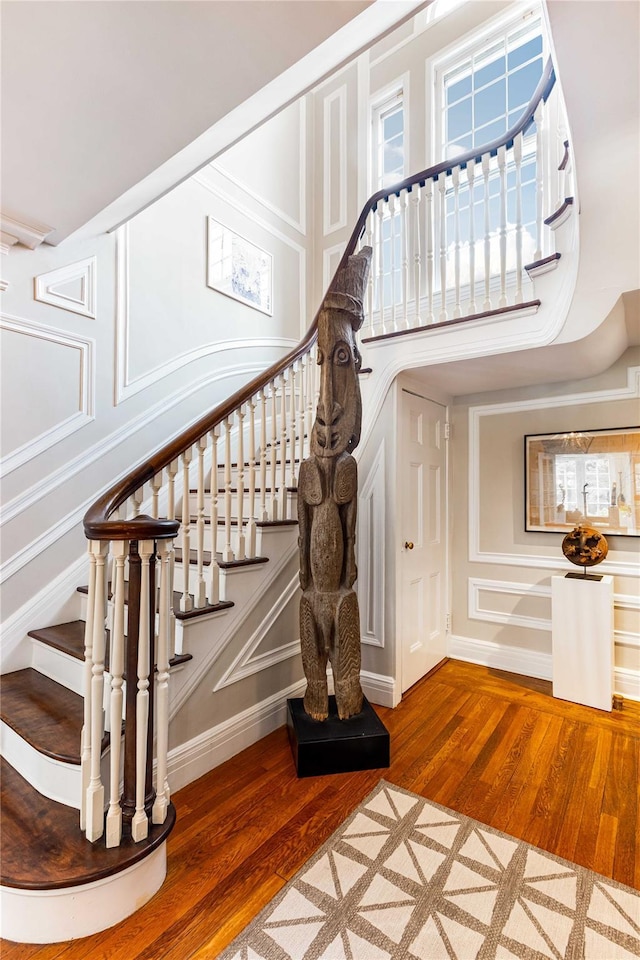 157 Alta Ave, Yonkers, NY 10705 - staircase with a decorative wall, a high ceiling, and hardwood / wood-style flooring