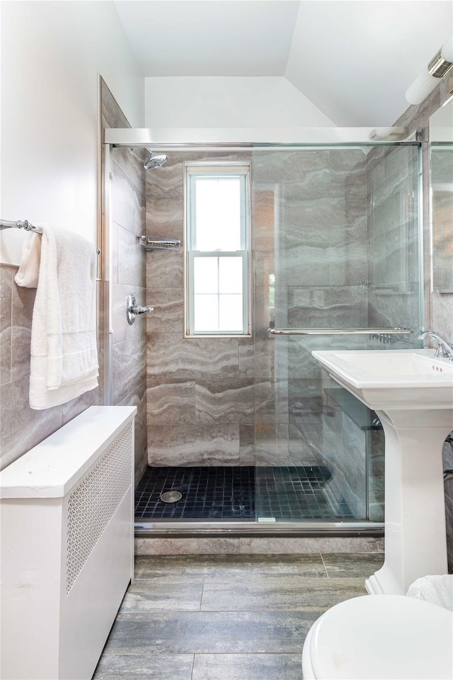 157 Alta Ave, Yonkers, NY 10705 - bathroom featuring a shower stall, tile walls, and vaulted ceiling