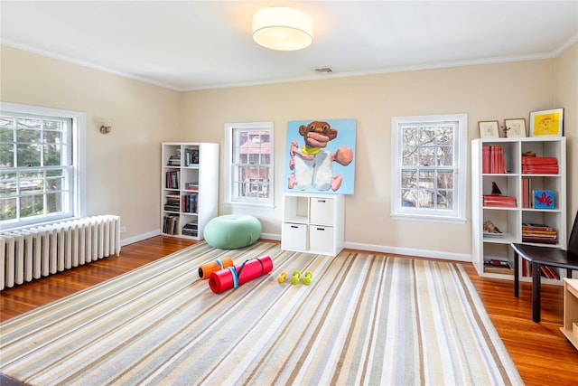 157 Alta Ave, Yonkers, NY 10705 - workout room with crown molding, radiator, baseboards, and wood finished floors