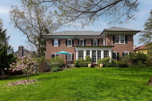 157 Alta Ave, Yonkers, NY 10705 - back of property with a yard, a sunroom, and brick siding