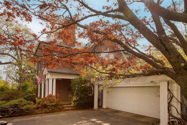 157 Alta Ave, Yonkers, NY 10705 - view of property hidden behind natural elements featuring concrete driveway and brick siding