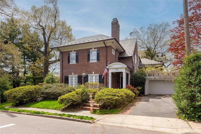 157 Alta Ave, Yonkers, NY 10705 - colonial-style house with a high end roof, brick siding, driveway, a garage, and a chimney