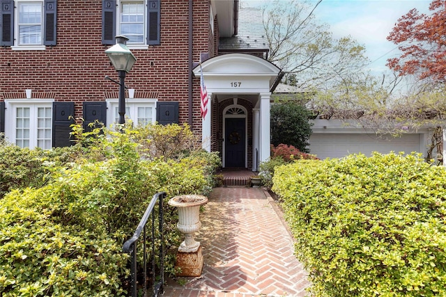 157 Alta Ave, Yonkers, NY 10705 - view of exterior entry with brick siding and an attached garage