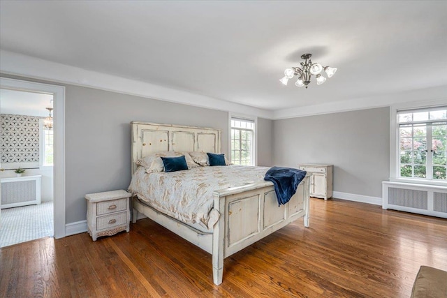 bedroom with radiator, a notable chandelier, multiple windows, and dark wood-type flooring