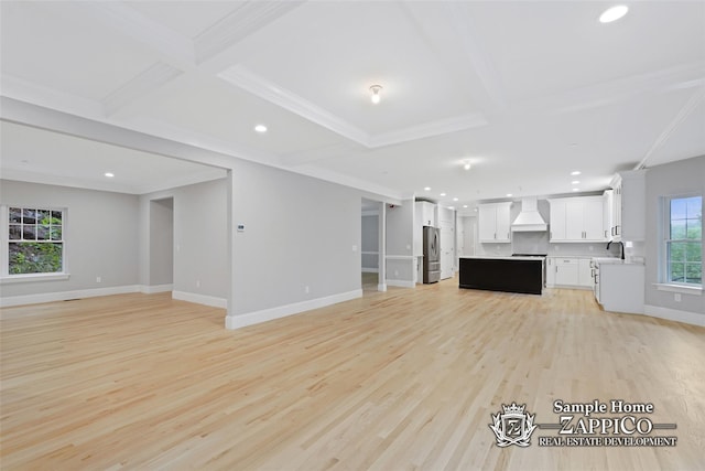 unfurnished living room with light wood-style floors, beam ceiling, coffered ceiling, and recessed lighting