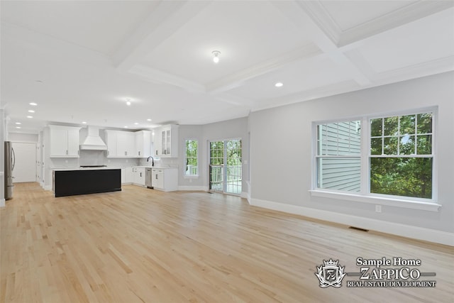 unfurnished living room featuring baseboards, beamed ceiling, and coffered ceiling