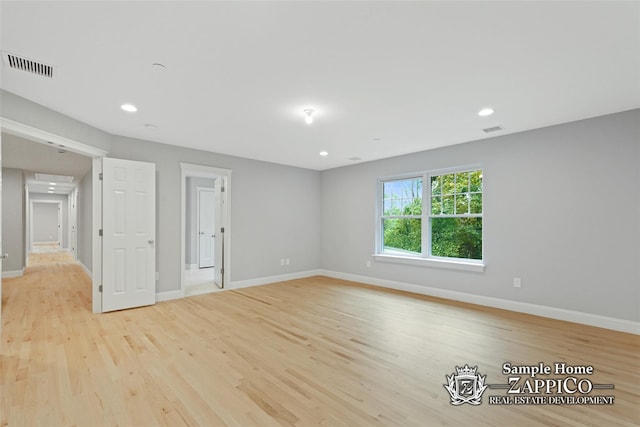unfurnished room featuring baseboards, recessed lighting, light wood-style flooring, and visible vents