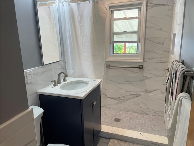 bathroom featuring vanity, curtained shower, and toilet