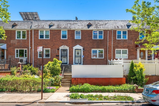 150-20 77th Ave, Kew Garden Hills, NY 11367 - view of property featuring brick siding, fence, and a high end roof