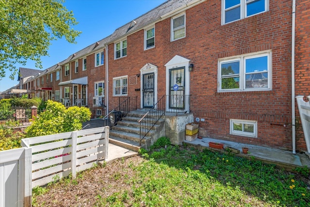150-20 77th Ave, Kew Garden Hills, NY 11367 - view of property with brick siding, fence, and a residential view