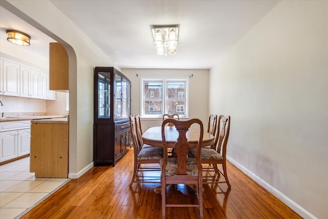150-20 77th Ave, Kew Garden Hills, NY 11367 - dining area featuring baseboards, light wood finished floors, and a notable chandelier