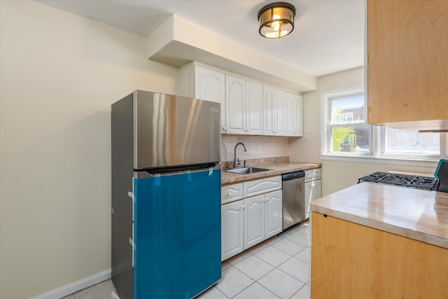 150-20 77th Ave, Kew Garden Hills, NY 11367 - kitchen with a sink, light countertops, light tile patterned flooring, stainless steel appliances, and white cabinetry