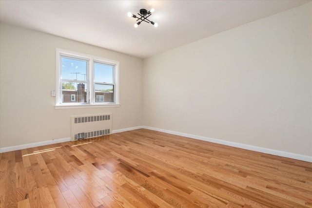 150-20 77th Ave, Kew Garden Hills, NY 11367 - spare room with baseboards, radiator heating unit, and light wood finished floors